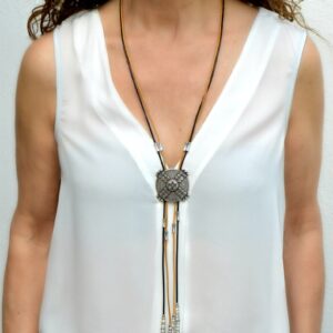 Long bolo tie necklace with silver plated metal and leather cords with feather endings.