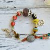 Bead bracelet with sustainable recycled glass beads, red jasper and lotus flower and om pendants.