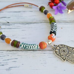 Choker necklace with large Hamsa Evil Eye pendant and African trade beads made of recycled glass in different colours.