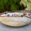 Ethnic choker necklace with adjustable leather cord and three recycled glass beads in blue, orange and green colors.