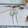 Long earrings in silver zamak and turquoise enamel with boho style spike pendant.