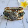 Wide cuf bracelet with natural moss agate and amazonite beads and leather with button closure in boho style.