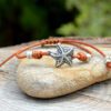 Adjustable leather bracelet with starfish in silver plated zamak.