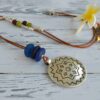 Long leather necklace with Aztec medallion and African blue recycled glass beads