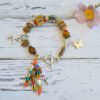 Bracelet with African colored beads and silver plated zamak pendants