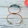 Adjustable leather bracelet with African recycled glass beads and brass beads