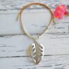 Choker with large pendant in the shape of monstera leaf with leather and zamak cord