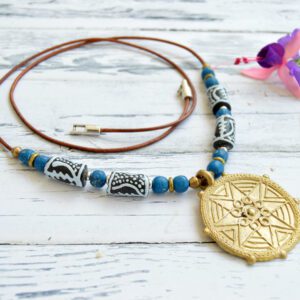 Long necklace with circular African brass pendant with inner star, recycled and hand painted blue glass beads and leather