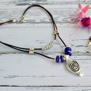 Choker necklace with ethnic pendant with silver plated spiral, double leather cord and blue recycled glass beads